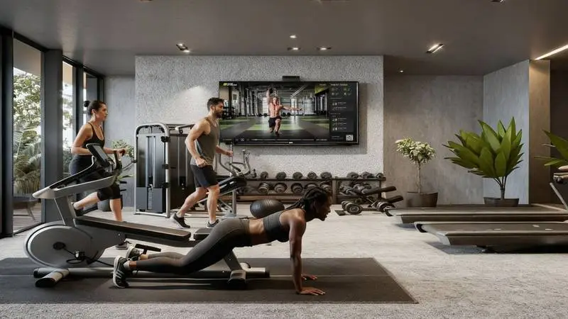Residents training together in an apartment building gym guided by GymStream